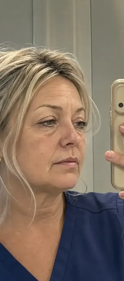 Woman checking her jawline and neck in a mirror